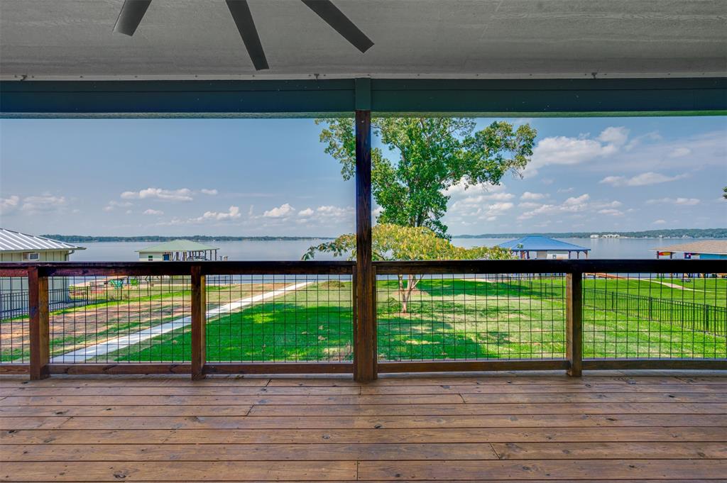 22107 Blue Water Road Chandler, TX 75758 - Photo 14 of 40 a view of empty room with wooden floor and fan
