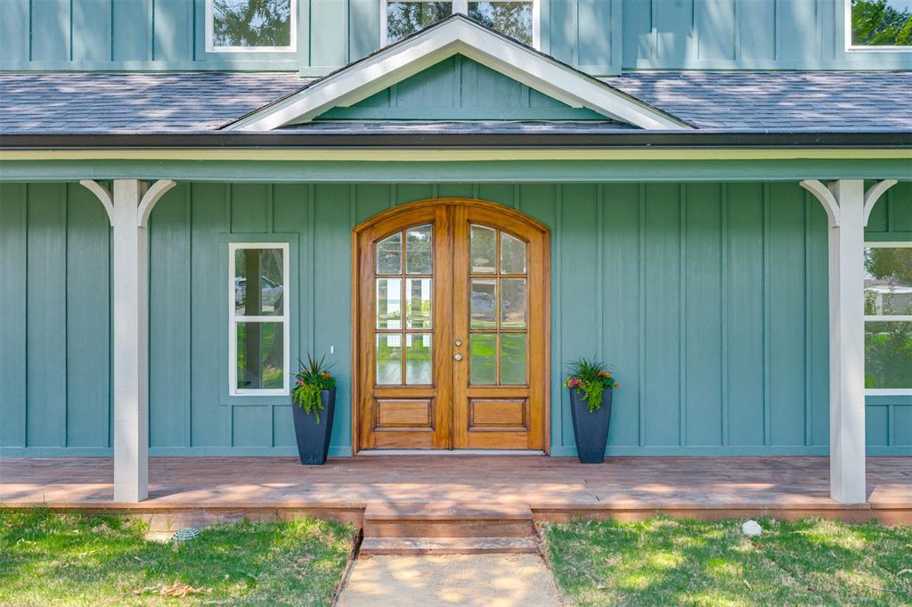 22107 Blue Water Road Chandler, TX 75758 - Photo 2 of 40 a front view of a house with garden