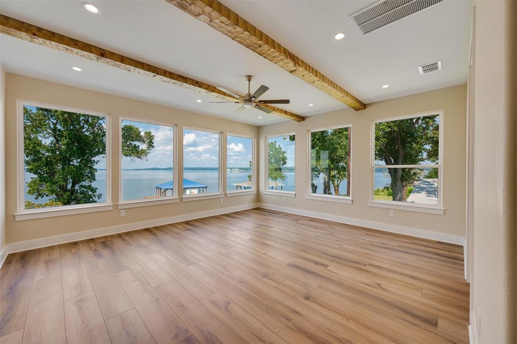 22107 Blue Water Road Chandler, TX 75758 - Photo 24 of 40 a view of an empty room with wooden floor and a window