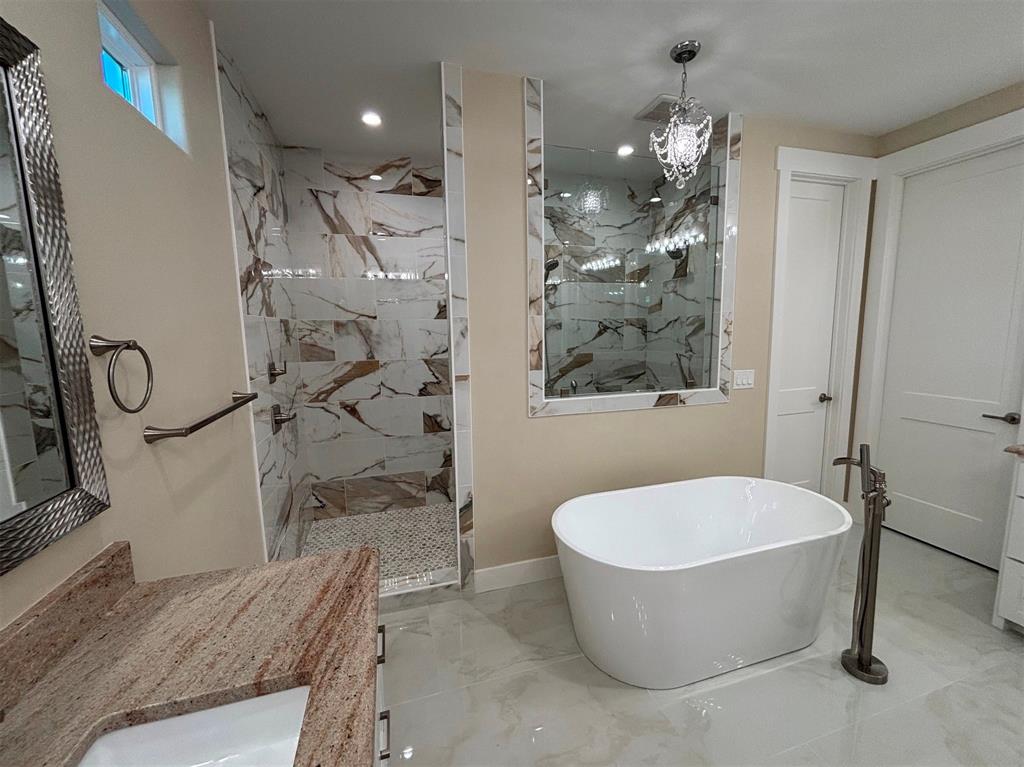 22107 Blue Water Road Chandler, TX 75758 - Photo 27 of 40 a bathroom with a granite countertop sink a toilet and shower