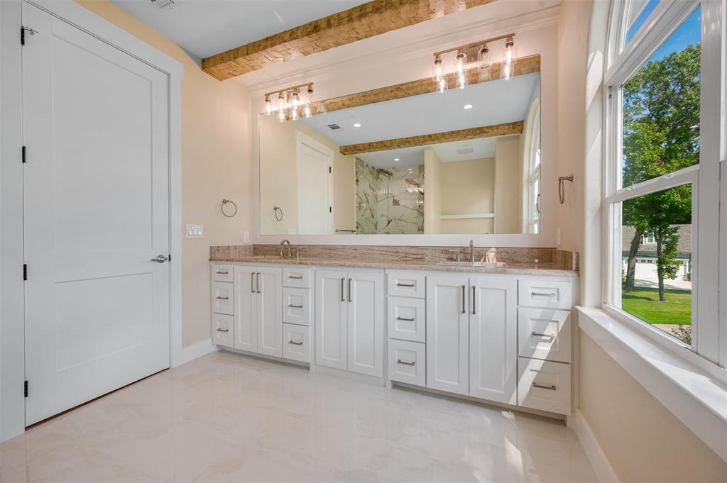 22107 Blue Water Road Chandler, TX 75758 - Photo 30 of 40 a bathroom with a granite countertop sink mirror and a bathtub