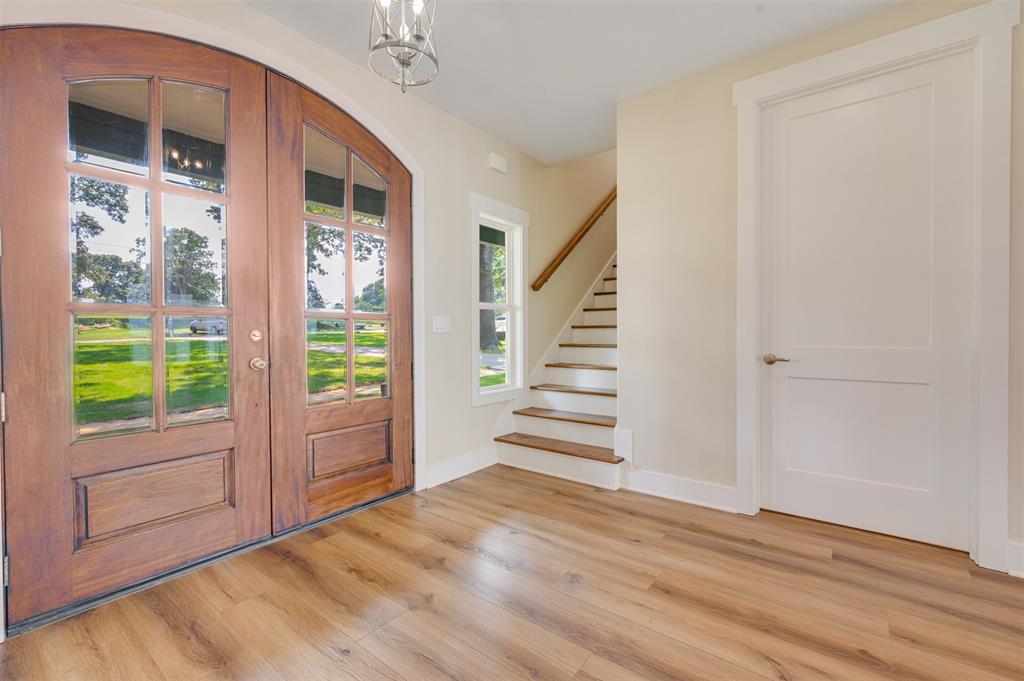 22107 Blue Water Road Chandler, TX 75758 - Photo 3 of 40 a view of an entryway with wooden floor and windows