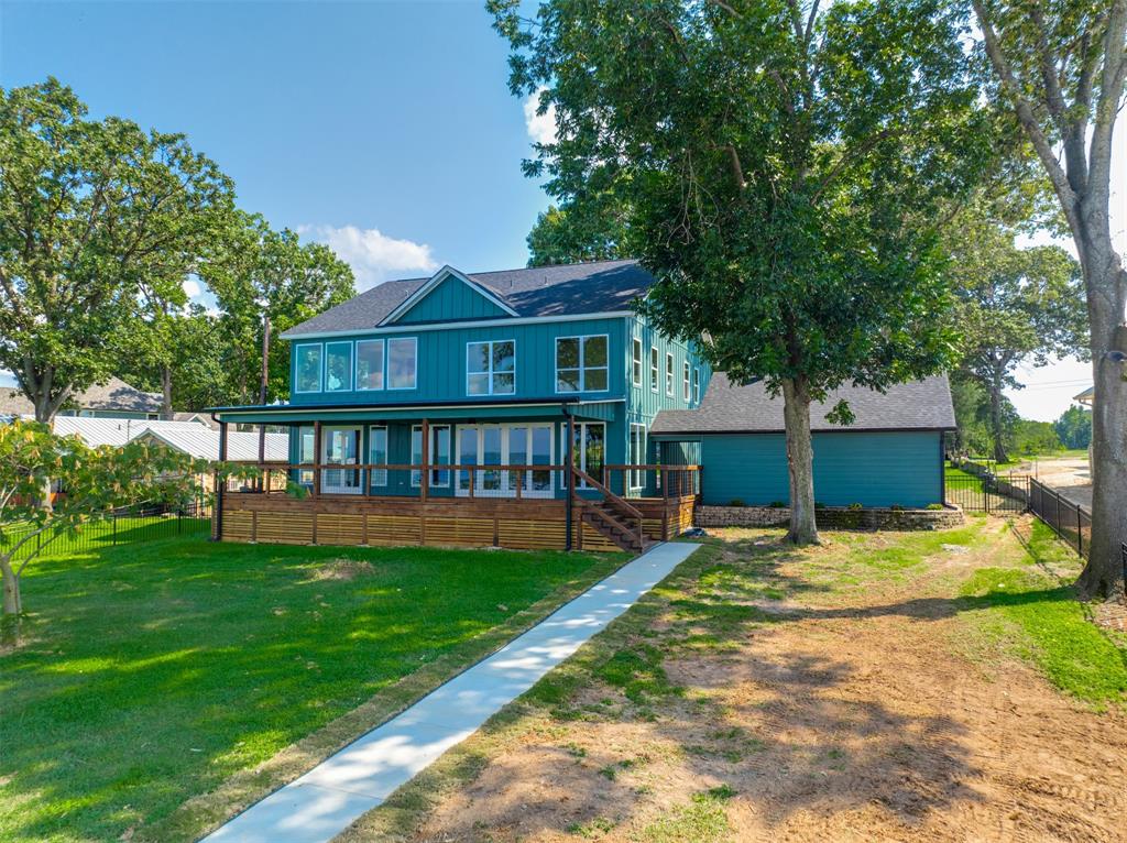 22107 Blue Water Road Chandler, TX 75758 - Photo 33 of 40 a view of a house with a yard deck and a small yard