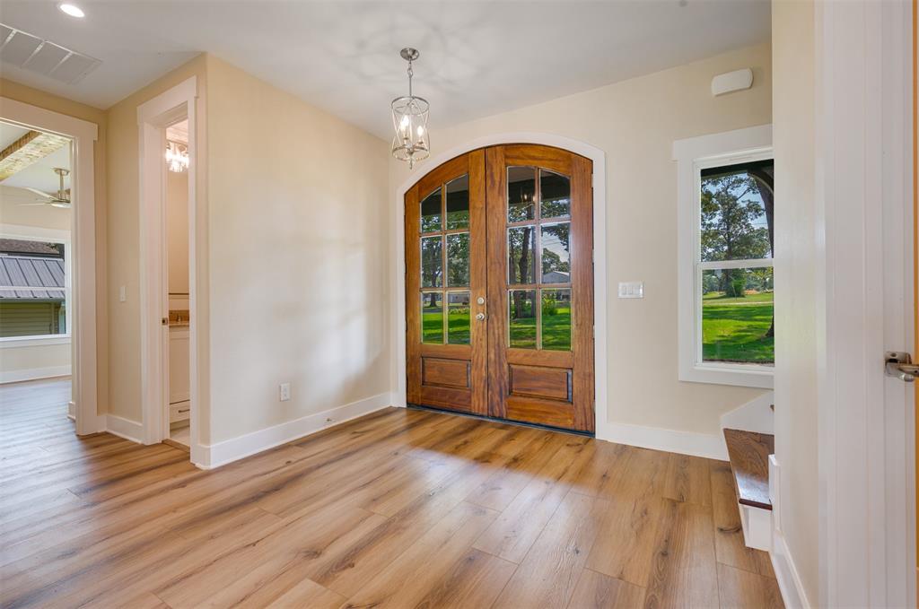 22107 Blue Water Road Chandler, TX 75758 - Photo 4 of 40 a view of empty room with wooden floor and fan