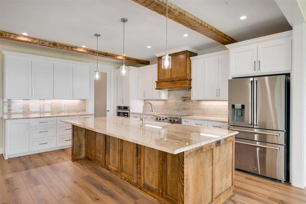 22107 Blue Water Road Chandler, TX 75758 - Photo 8 of 40 a kitchen with a sink cabinets stainless steel appliances and a window