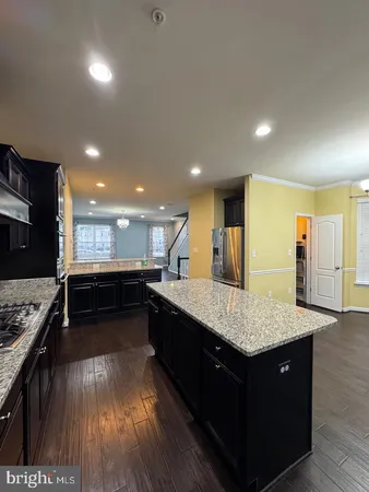 a kitchen with stainless steel appliances granite countertop sink stove and refrigerator