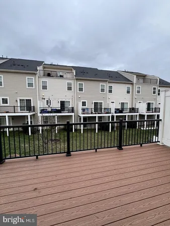 a view of a roof deck with wooden floor and fence