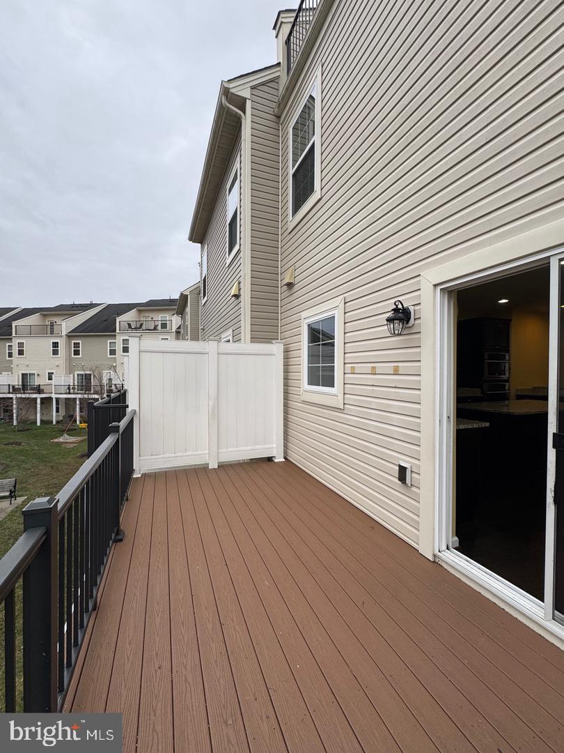 7925 Alchemy Way Elkridge, MD 21075 - Photo 28 of 46 a view of a roof deck with wooden floor and fence