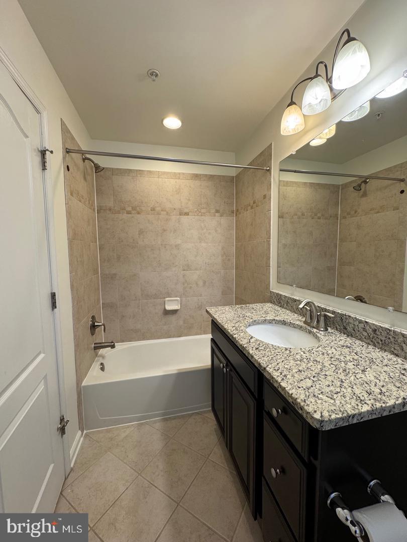 7925 Alchemy Way Elkridge, MD 21075 - Photo 39 of 46 a bathroom with a granite countertop sink a toilet and shower