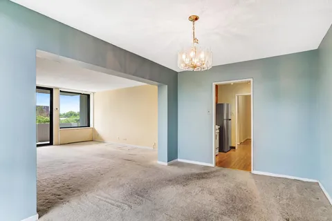 a view of a hallway with a chandelier