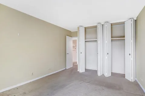 an empty room with a empty space and sliding door