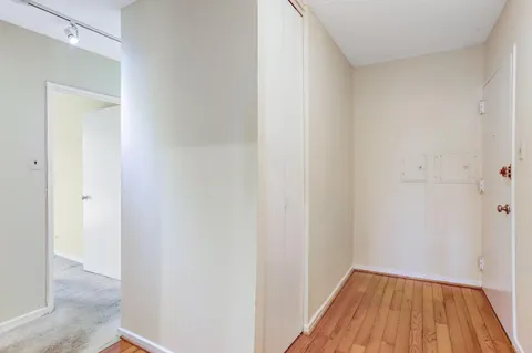 a view of a hallway with wooden floor