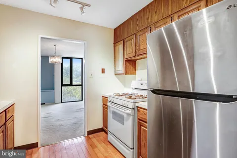 a kitchen with window and white cabinets