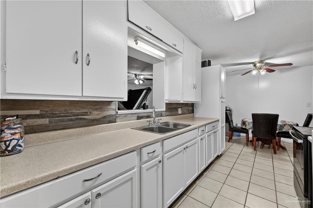 616 5th Street Weslaco, TX 78596 - Photo 23 of 33 a kitchen with a sink and cabinets