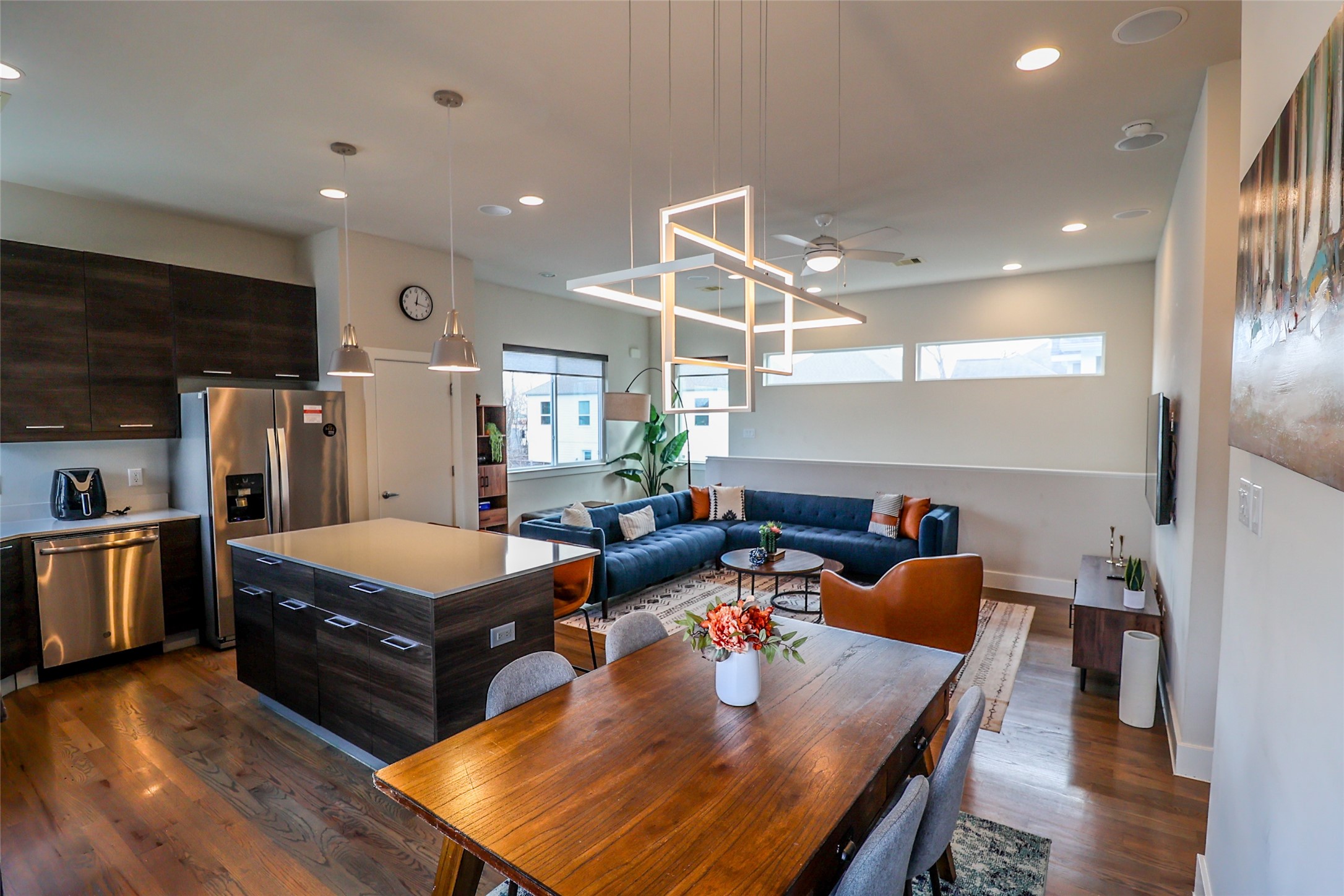 a living room with furniture pool table and kitchen view