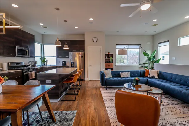 a dining room with furniture a rug and wooden floor