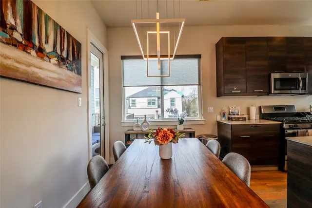 a living room with dining room and wooden floor