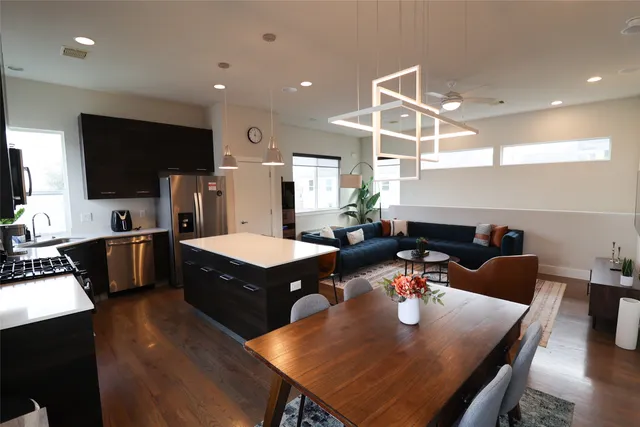 a kitchen with stainless steel appliances granite countertop a stove a sink and a microwave