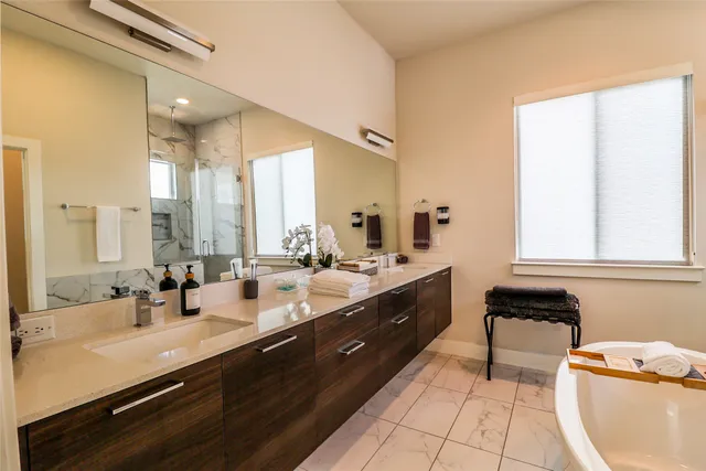 a bathroom with a sink a toilet and shower