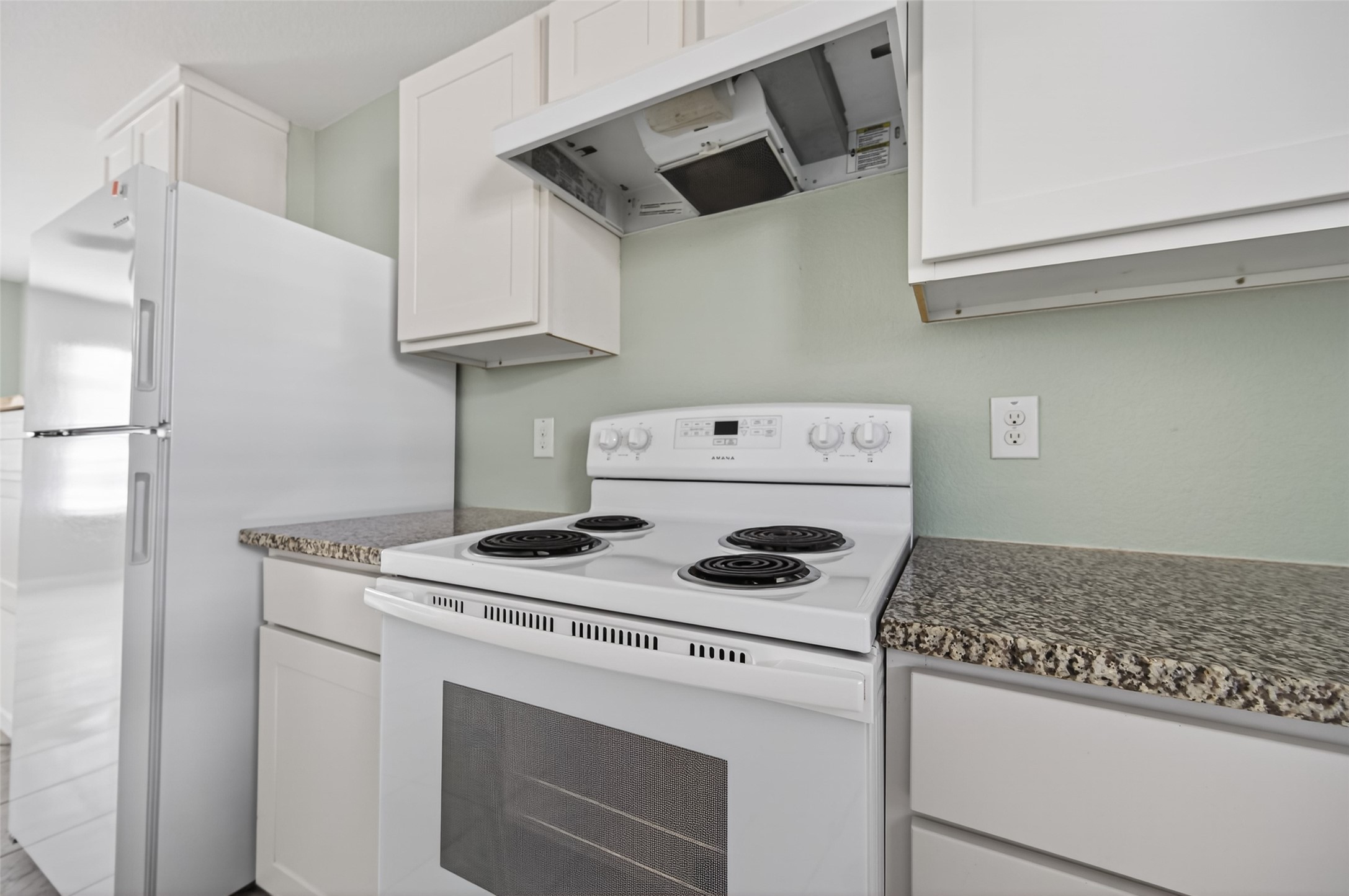 15149 Austin Road Willis, TX 77378 - Photo 13 of 31 a kitchen with cabinets stove and white stainless steel appliances