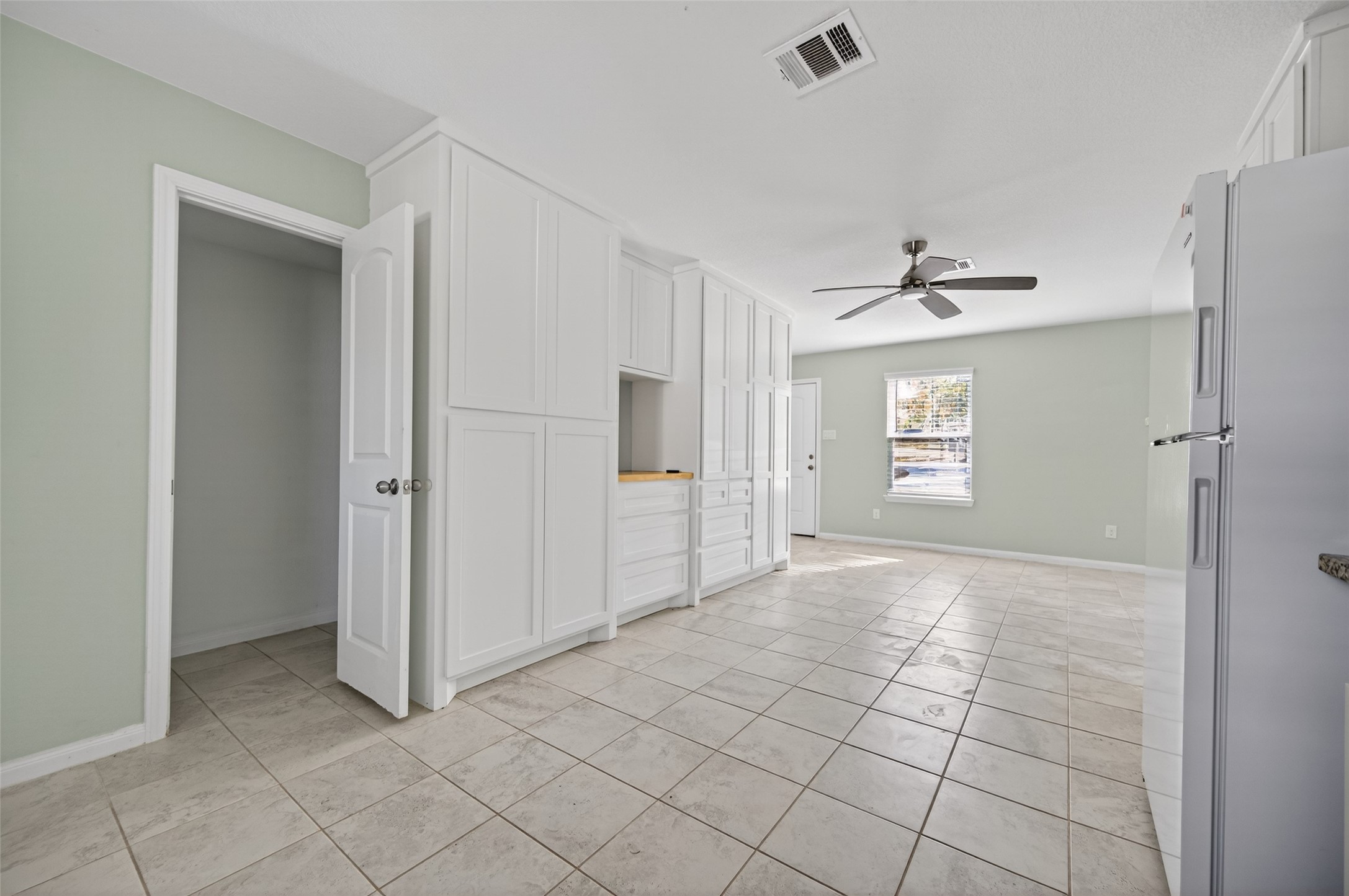 15149 Austin Road Willis, TX 77378 - Photo 15 of 31 a view of an empty room with window and chandelier fan