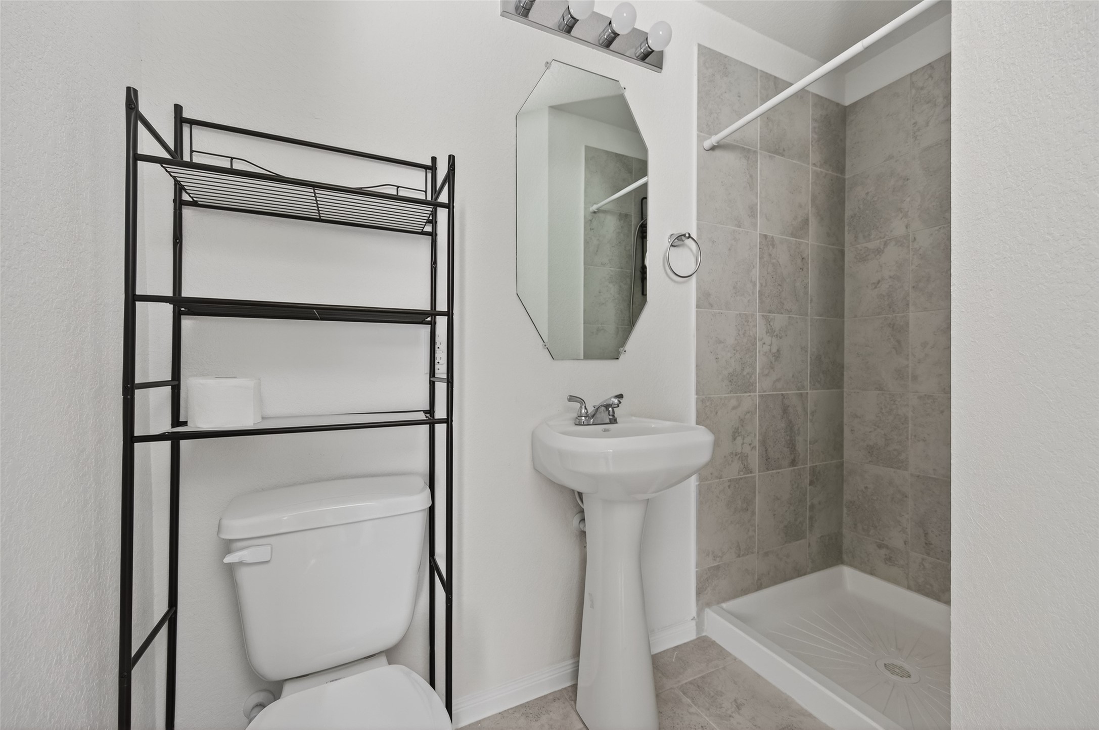 15149 Austin Road Willis, TX 77378 - Photo 21 of 31 a bathroom with a shower toilet and sink