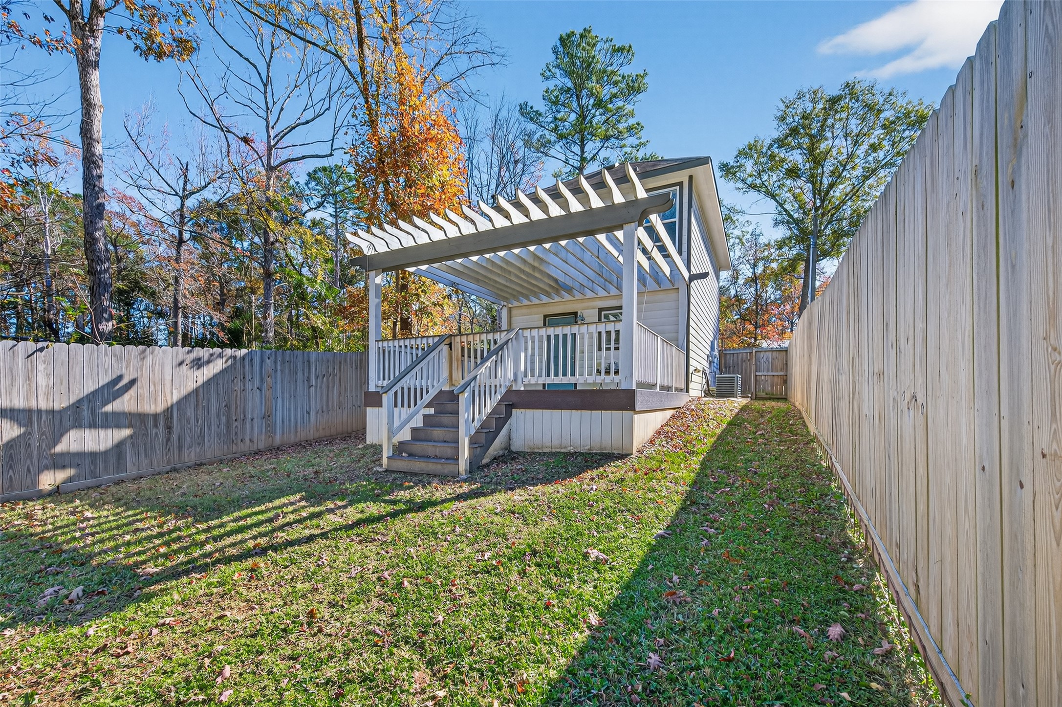 15149 Austin Road Willis, TX 77378 - Photo 30 of 31 a view of a backyard with a small cabin and chair