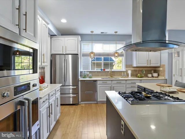 a kitchen with a stove top oven cabinets and a table