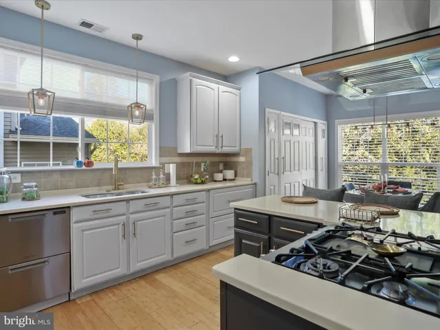 a kitchen with appliances a sink and cabinets