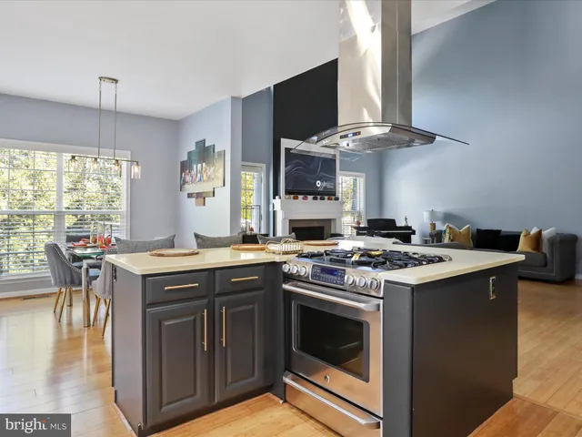 a view of a dining room with furniture a kitchen and chandelier