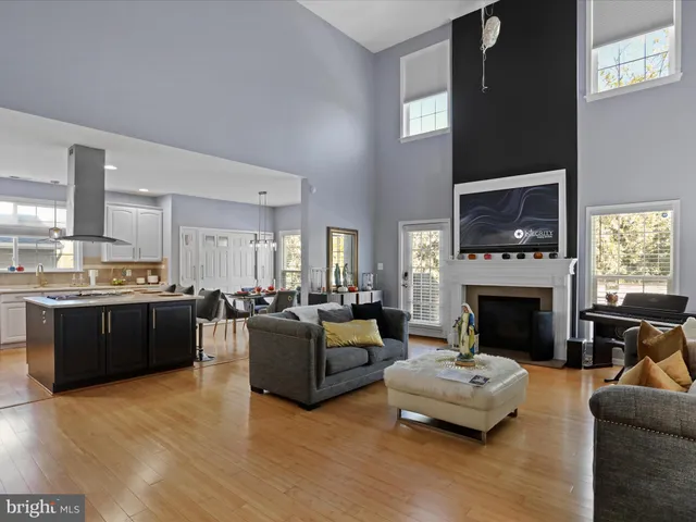 a white sink sitting under a mirror