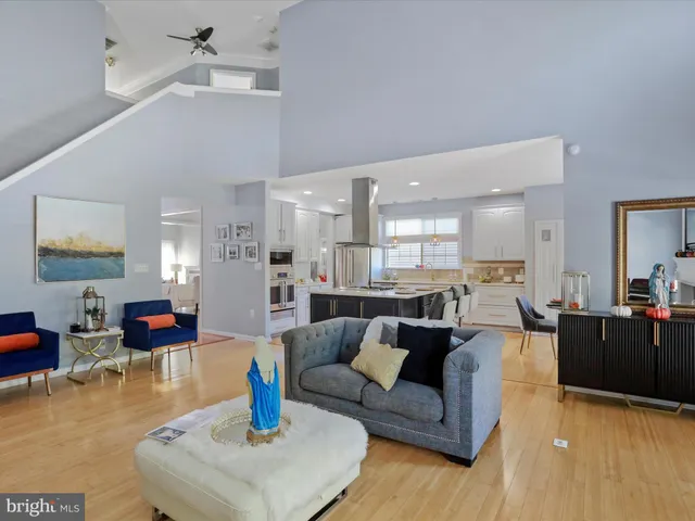 a living room with furniture a flat screen tv and a window