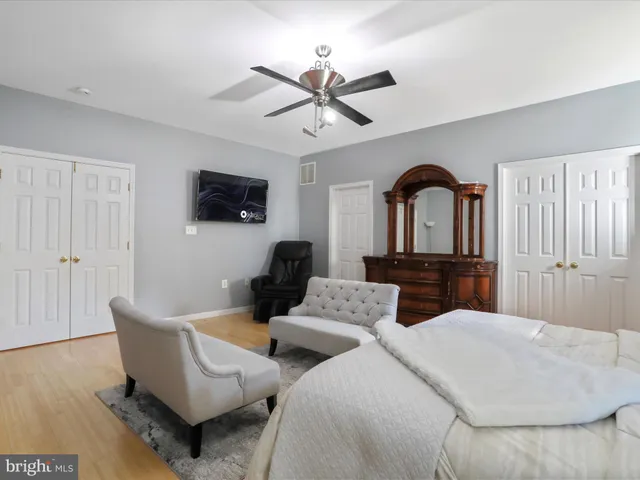 a bedroom with a large bed and a dresser