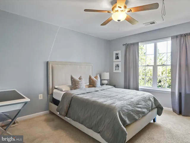 a bedroom with a bed and a television