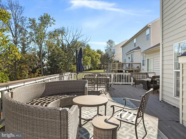 a living room with furniture a flat screen tv and kitchen view