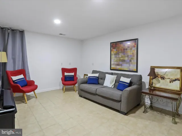 an aerial view of a city with lots of residential buildings and mountain view in back