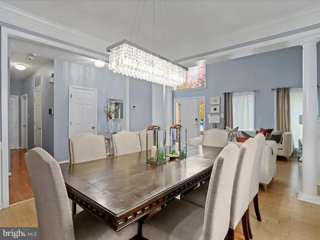 a large kitchen with kitchen island a large counter top space a sink stainless steel appliances and cabinets