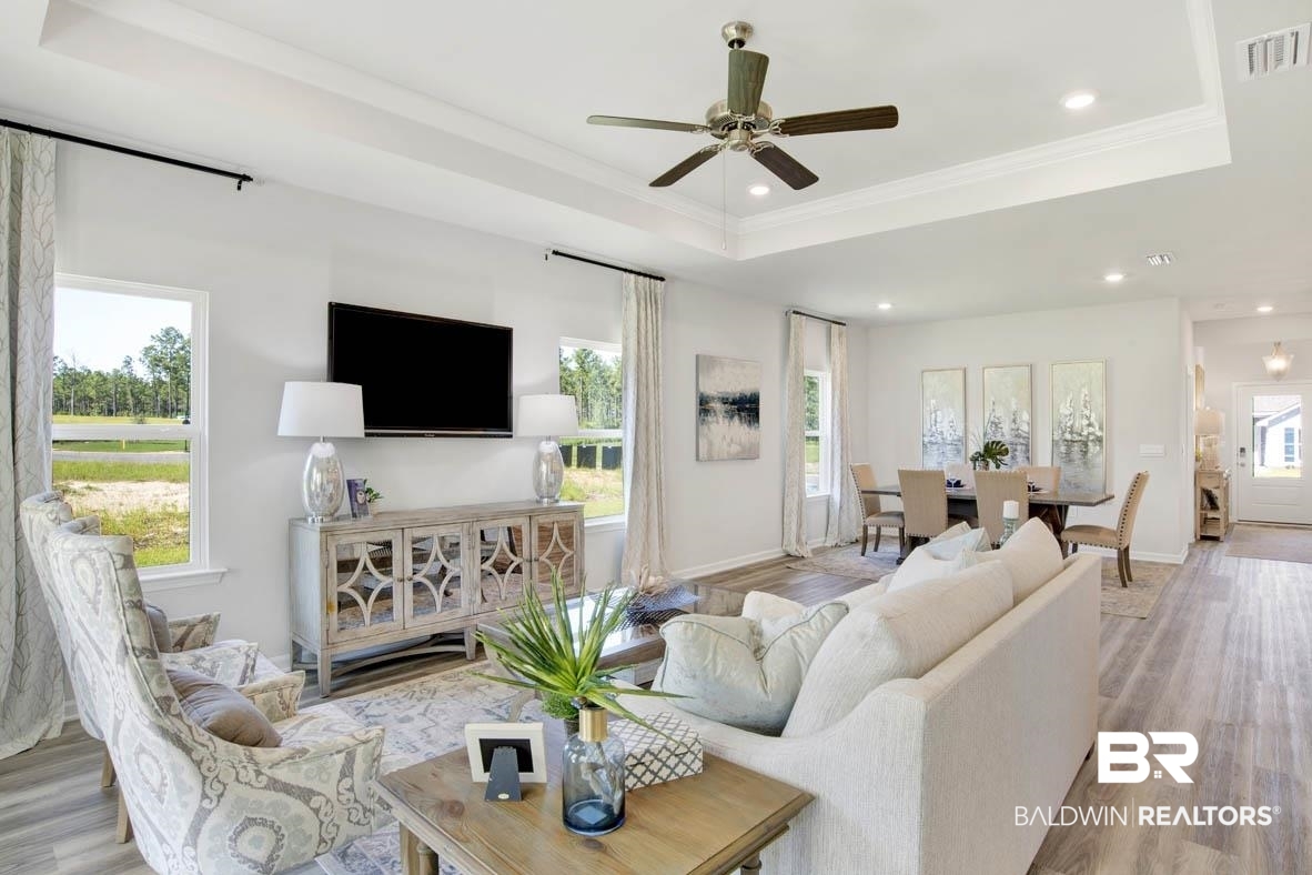 13822 Antler Hl Road Daphne, AL 36527 - Photo 29 of 39 Living room with light wood-type flooring, a wealth of natural light, and a raised ceiling