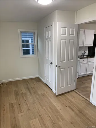 a view of a kitchen with wooden floor and electronic appliances