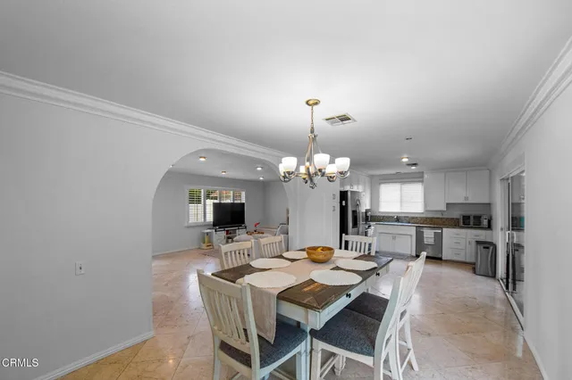 a kitchen with granite countertop a refrigerator and a stove top oven
