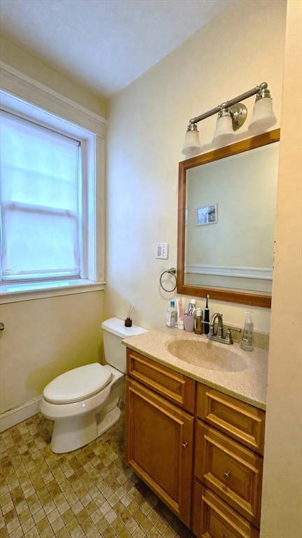 57 Alton Place, Unit 3 Brookline, MA 02446 - Photo 13 of 13 a bathroom with a sink a toilet and mirror