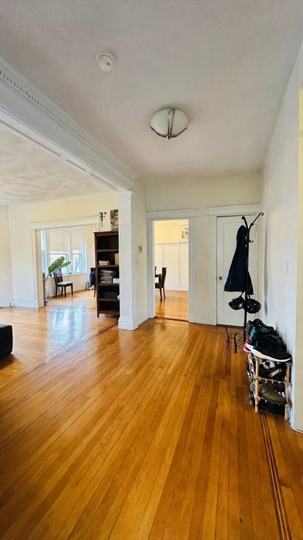 57 Alton Place, Unit 3 Brookline, MA 02446 - Photo 4 of 13 a view of a room with gym equipment and wooden floor