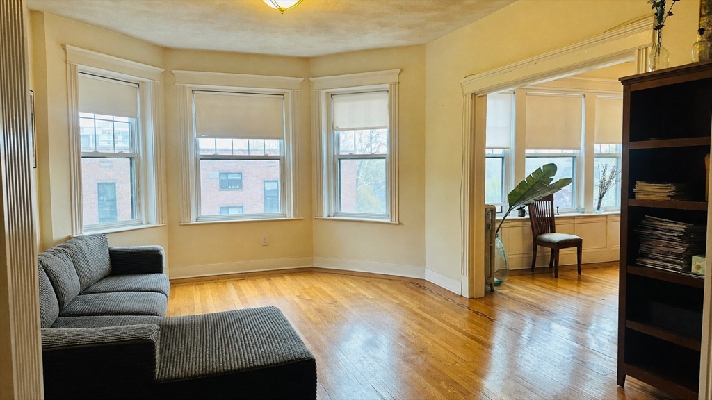 57 Alton Place, Unit 3 Brookline, MA 02446 - Photo 5 of 13 a living room with furniture and a flat screen tv