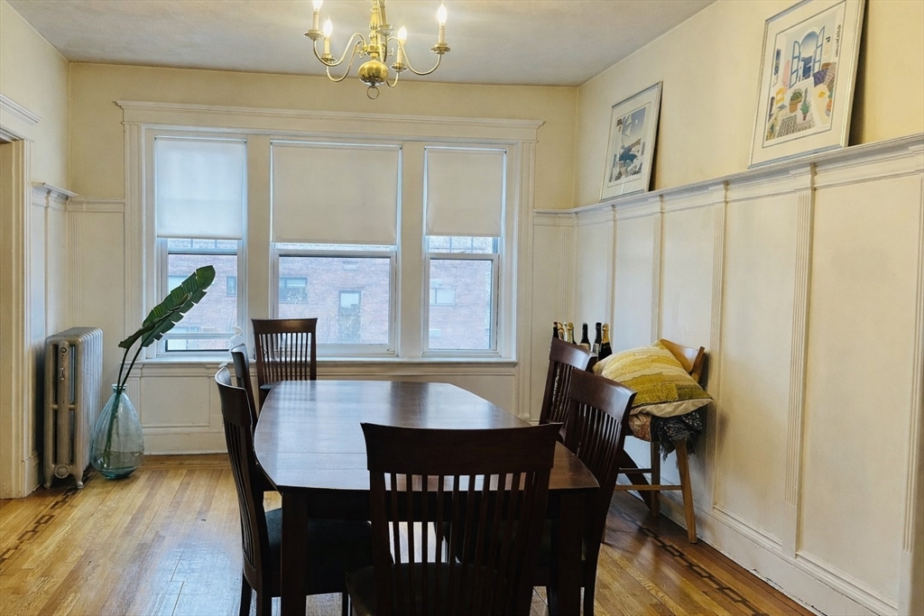 57 Alton Place, Unit 3 Brookline, MA 02446 - Photo 6 of 13 a view of a dining room with furniture and wooden floor