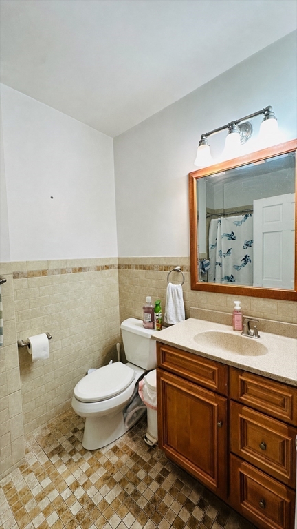 57 Alton Place, Unit 3 Brookline, MA 02446 - Photo 9 of 13 a bathroom with a sink toilet and mirror
