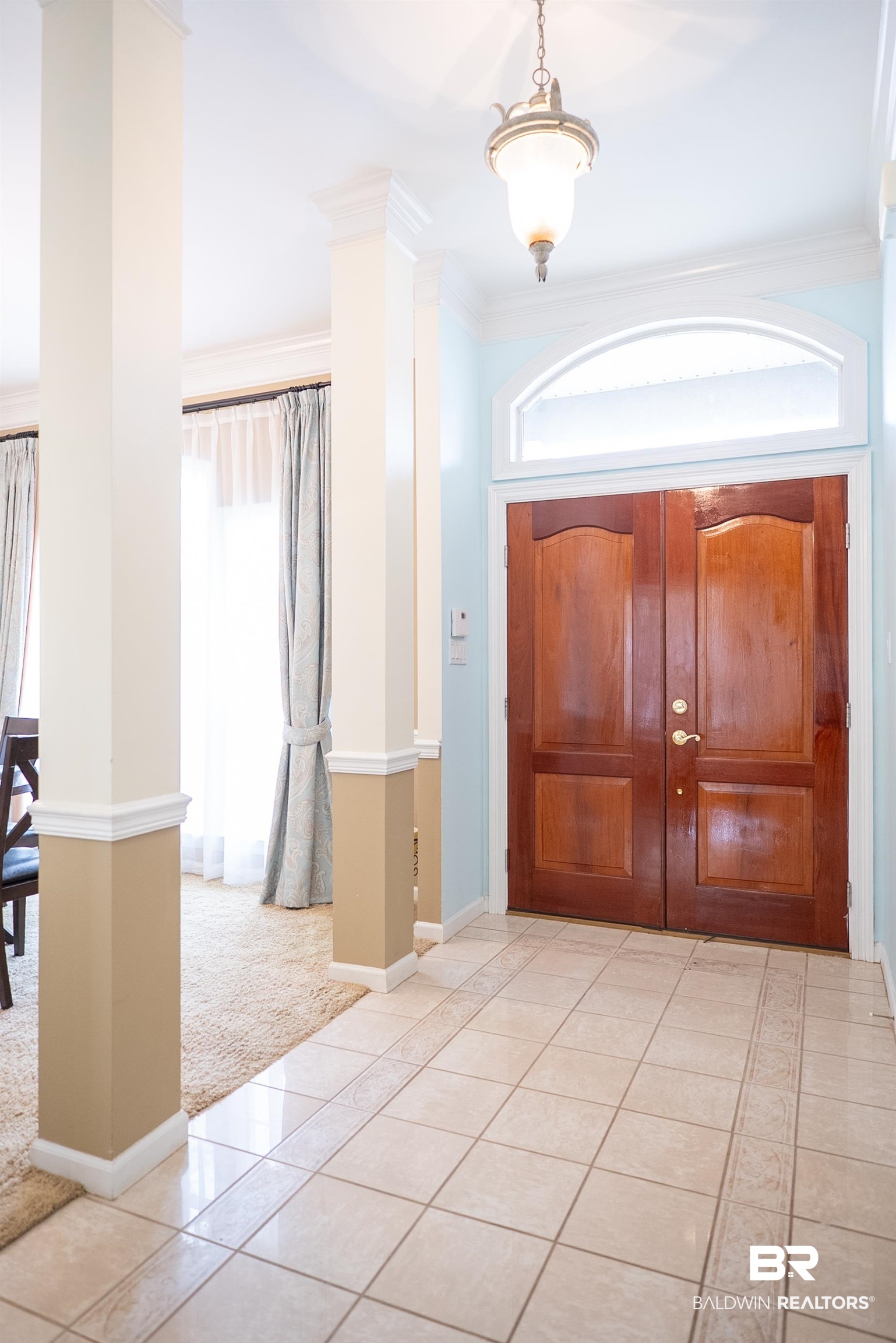 10023 Springfield Court Mobile, AL 36695 - Photo 5 of 50 Entrance foyer featuring light tile patterned flooring, light colored carpet, ornamental molding, and ornate columns