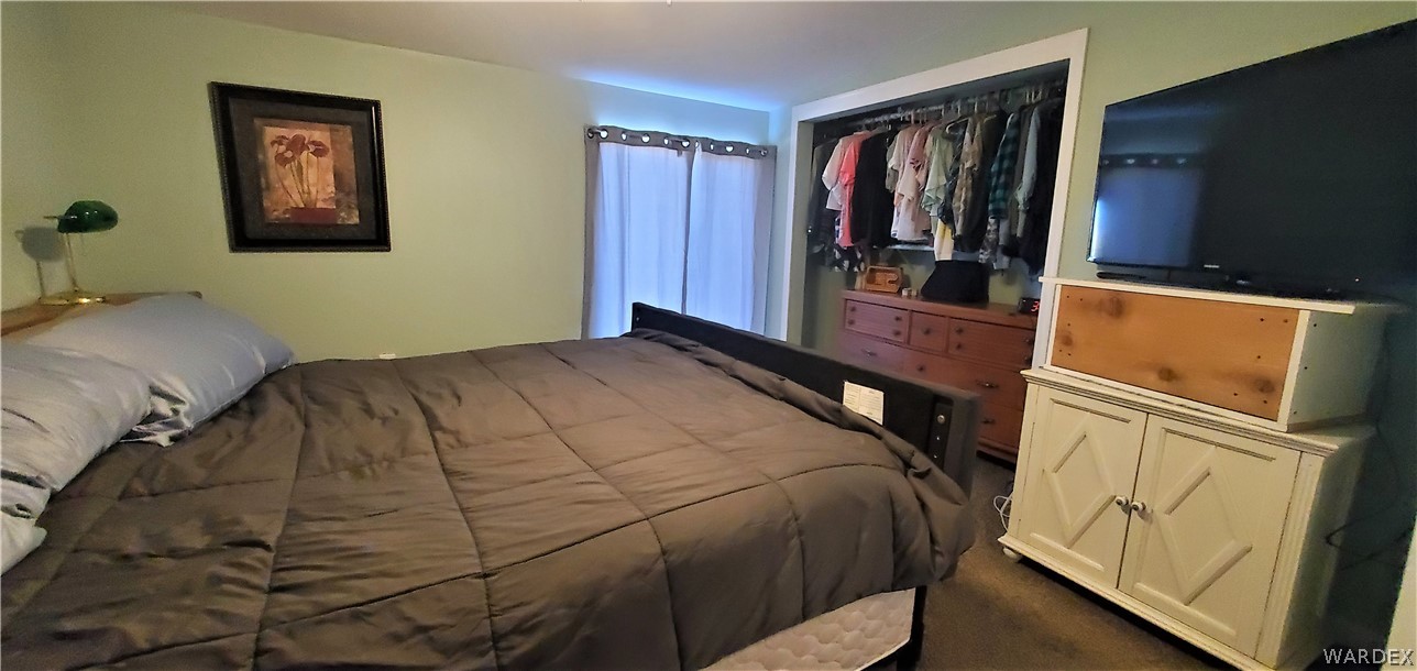 2194 Dewey Road Golden Valley, AZ 86413 - Photo 54 of 95 a bedroom with a bed and a mirror