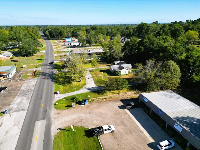 an aerial view of a swimming pool with a yard