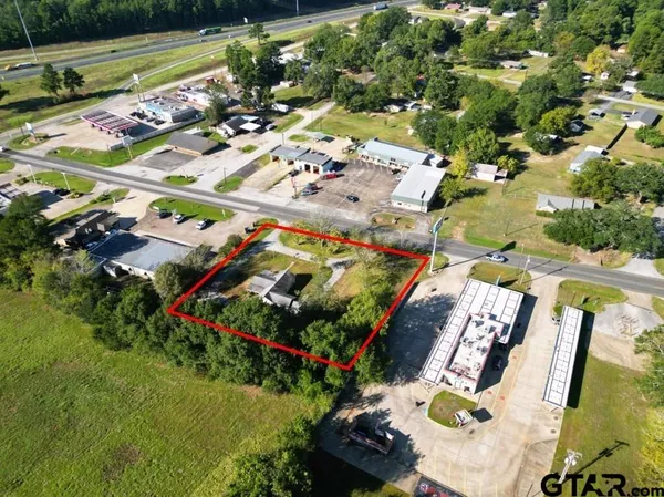 an aerial view of swimming pool patio and mountain view in back