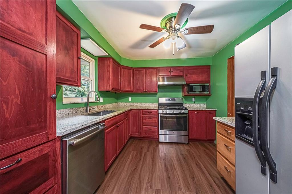 421 Sharon Road Coraopolis, PA 15108 - Photo 11 of 25 Kitchen features a large sink, granite counter tops SS refrigerator, dishwasher, and gas stove.